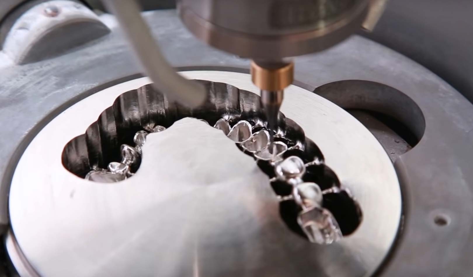 Real CNC milling machine producing a zirconia bridge